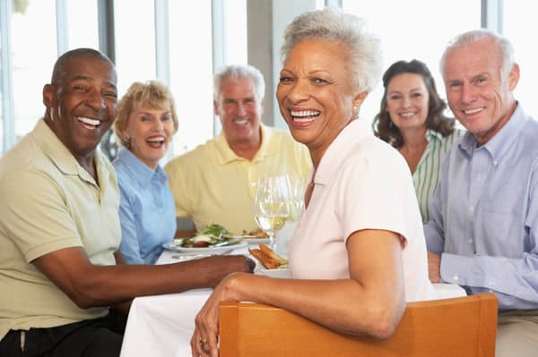 Group of senior citizens enjoying a restaurant meal